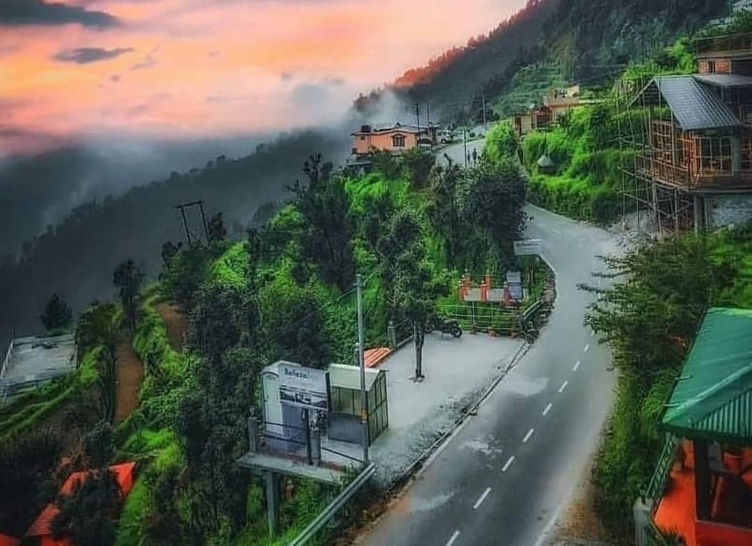 Kanatal hill station with colorful houses and mountain backdrop